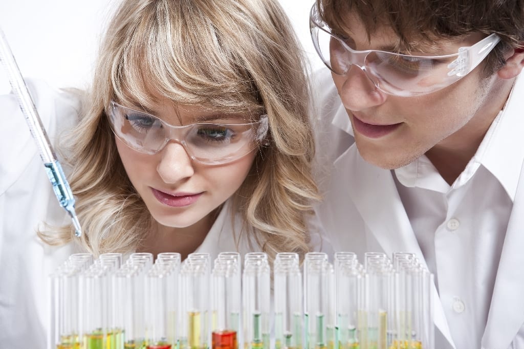 Female and male researchers examining test tubes