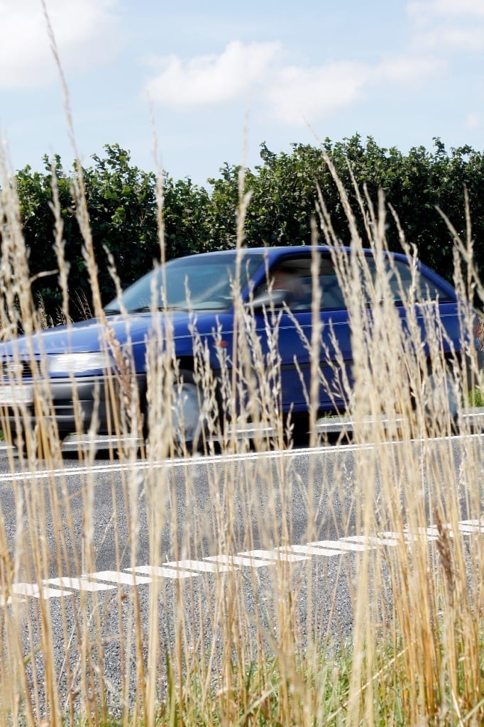 Four door sedan on a local roadway