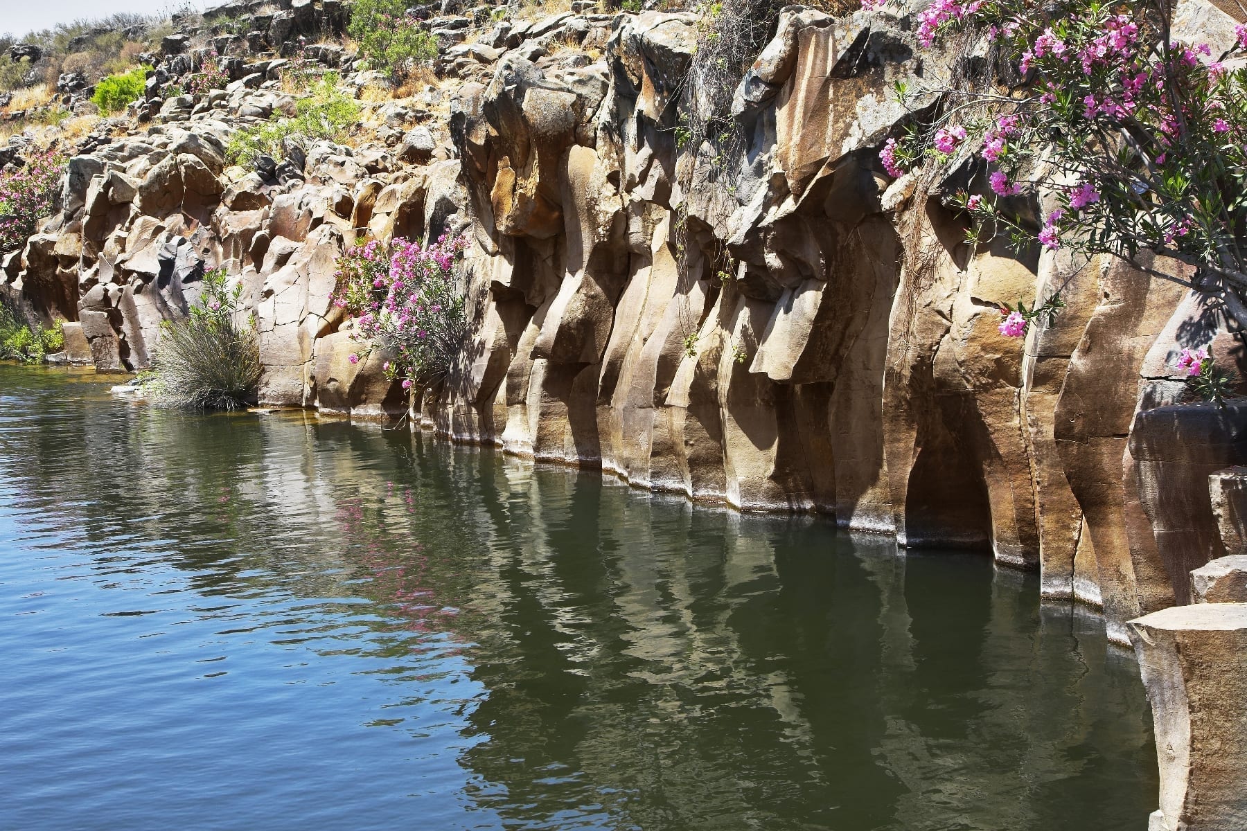 Basalt Rock Surrounding a Reservoir.