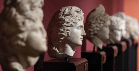 Line of ancient greek busts with center bust in focus