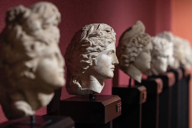 Line of ancient greek busts with center bust in focus